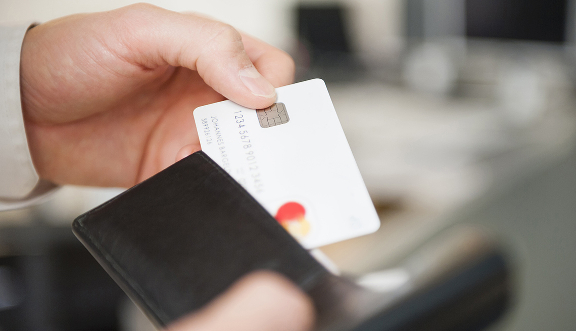 Man pulls credit card from wallet