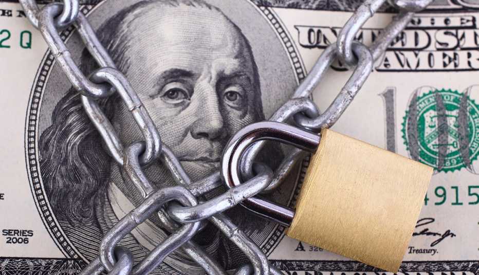 A one hundred dollar bill with chains and a lock