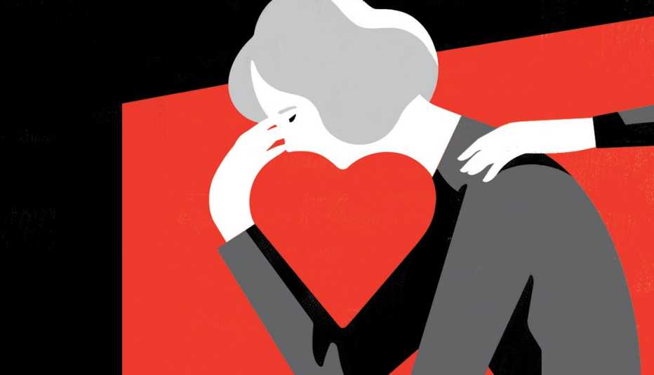 hand reaching out to comfort a brokenhearted woman with head in hand and the negative space between her face and hand forms a heart shape