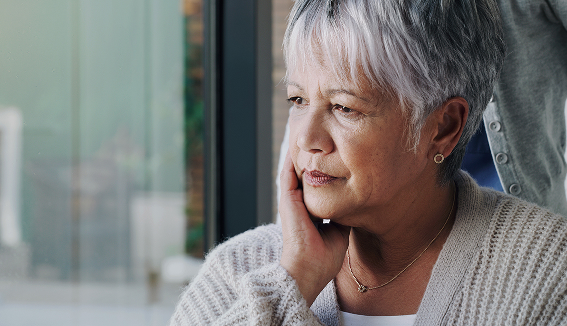 Shot of a senior woman in a wheelchair looking sad at a nursing home