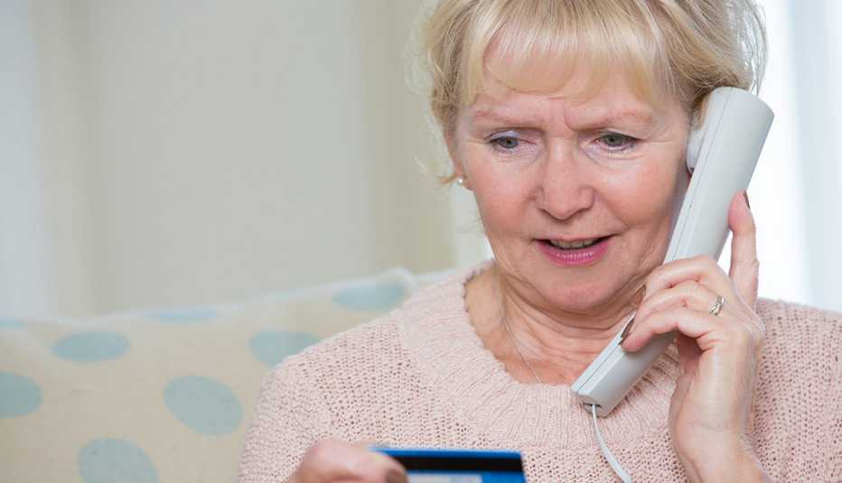 Senior Woman Giving Credit Card Details On The Phone