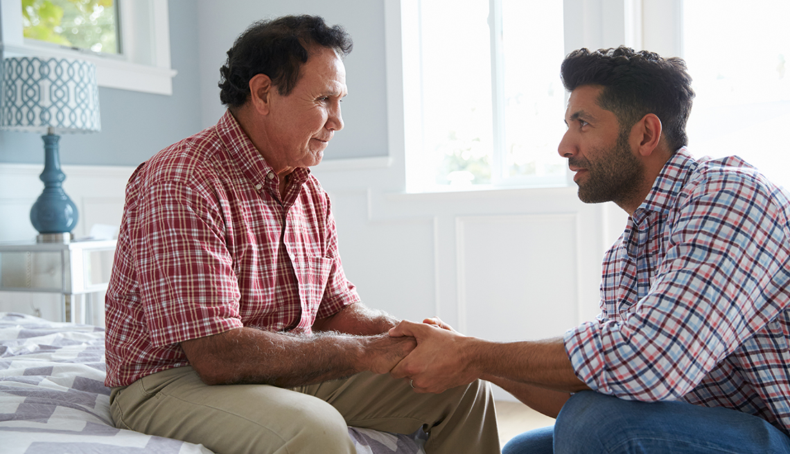 Son comforting adult father