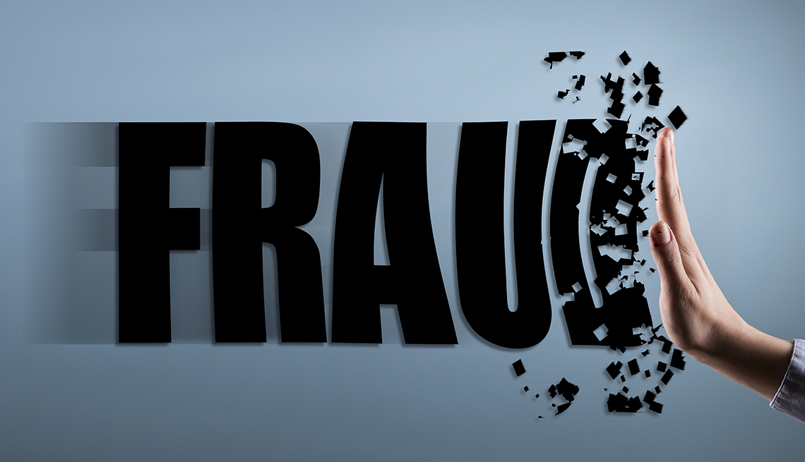 a hand pushing back on the word fraud and the word is breaking up