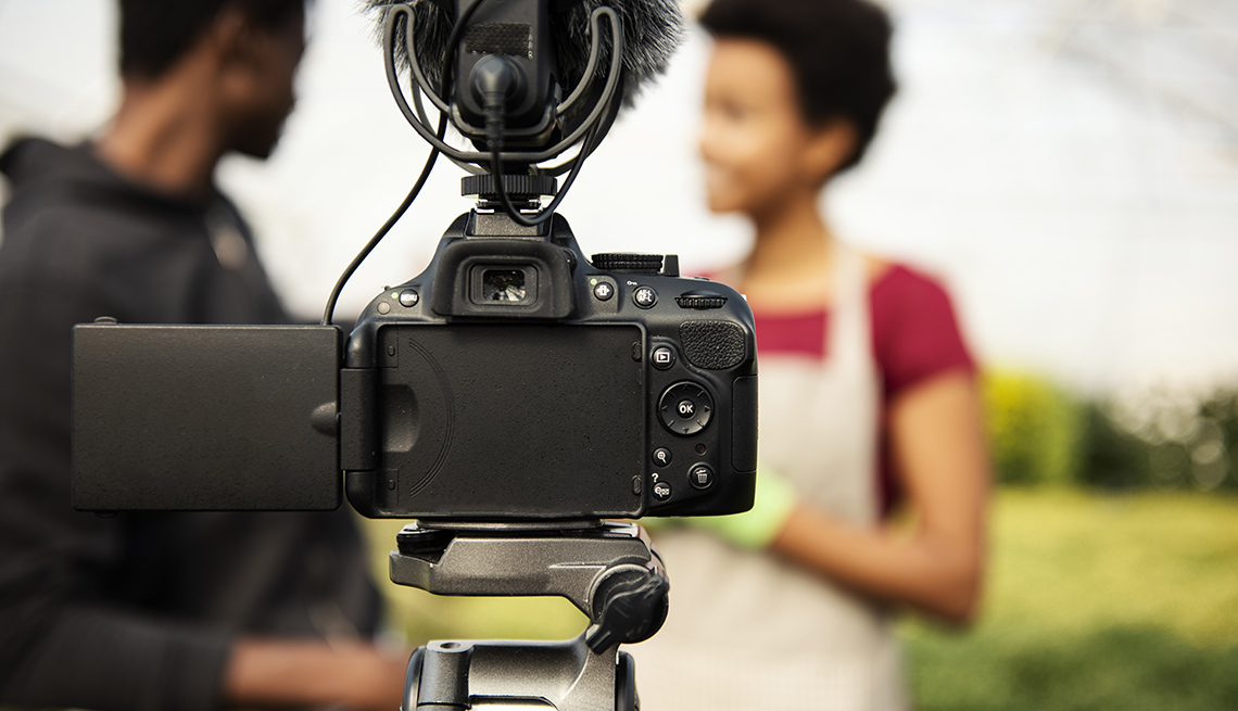 Young couple vlogging in greehouse