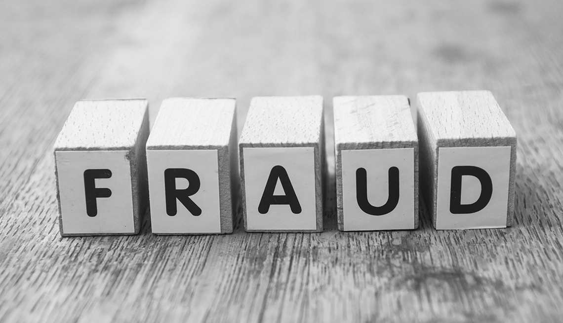 The words "Fraud" spelled out on wooden cubes