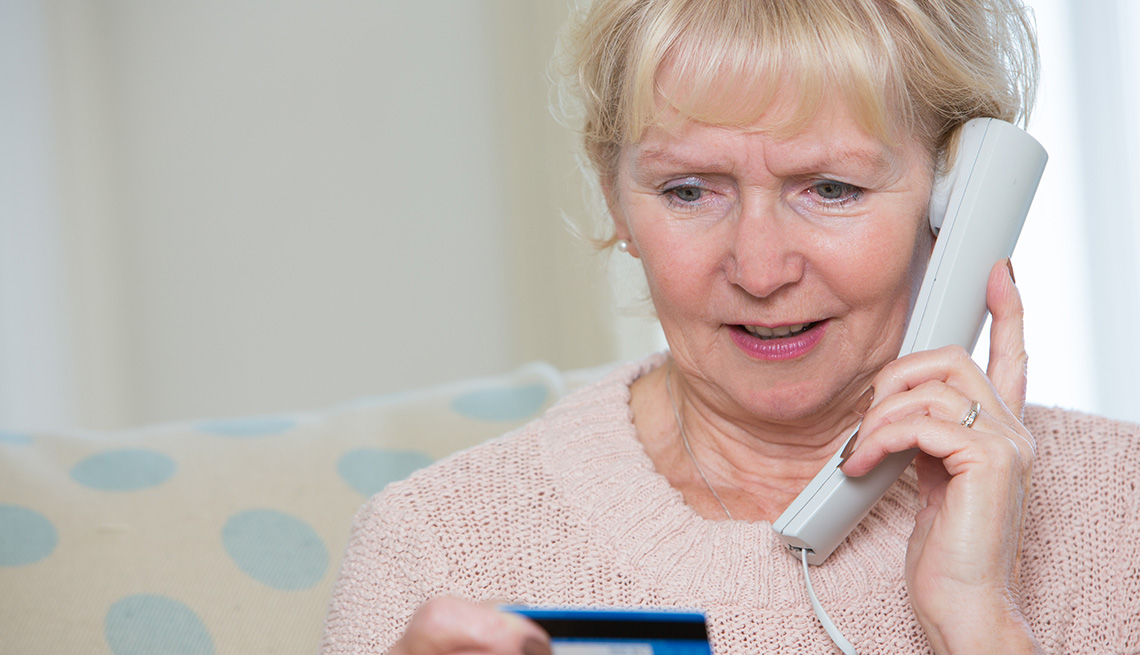 Senior Woman Giving Credit Card Details On The Phone