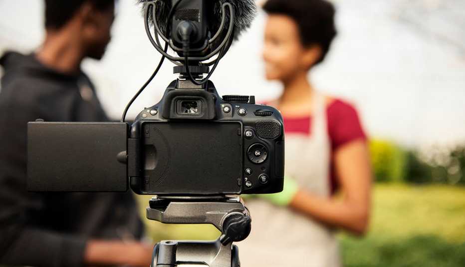 Young couple vlogging in greehouse