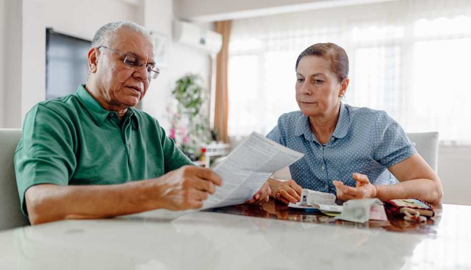 Couple at home with many bills